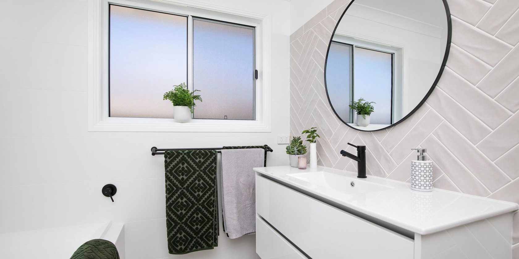 We're loving these herringbone tiles and round mirror! 